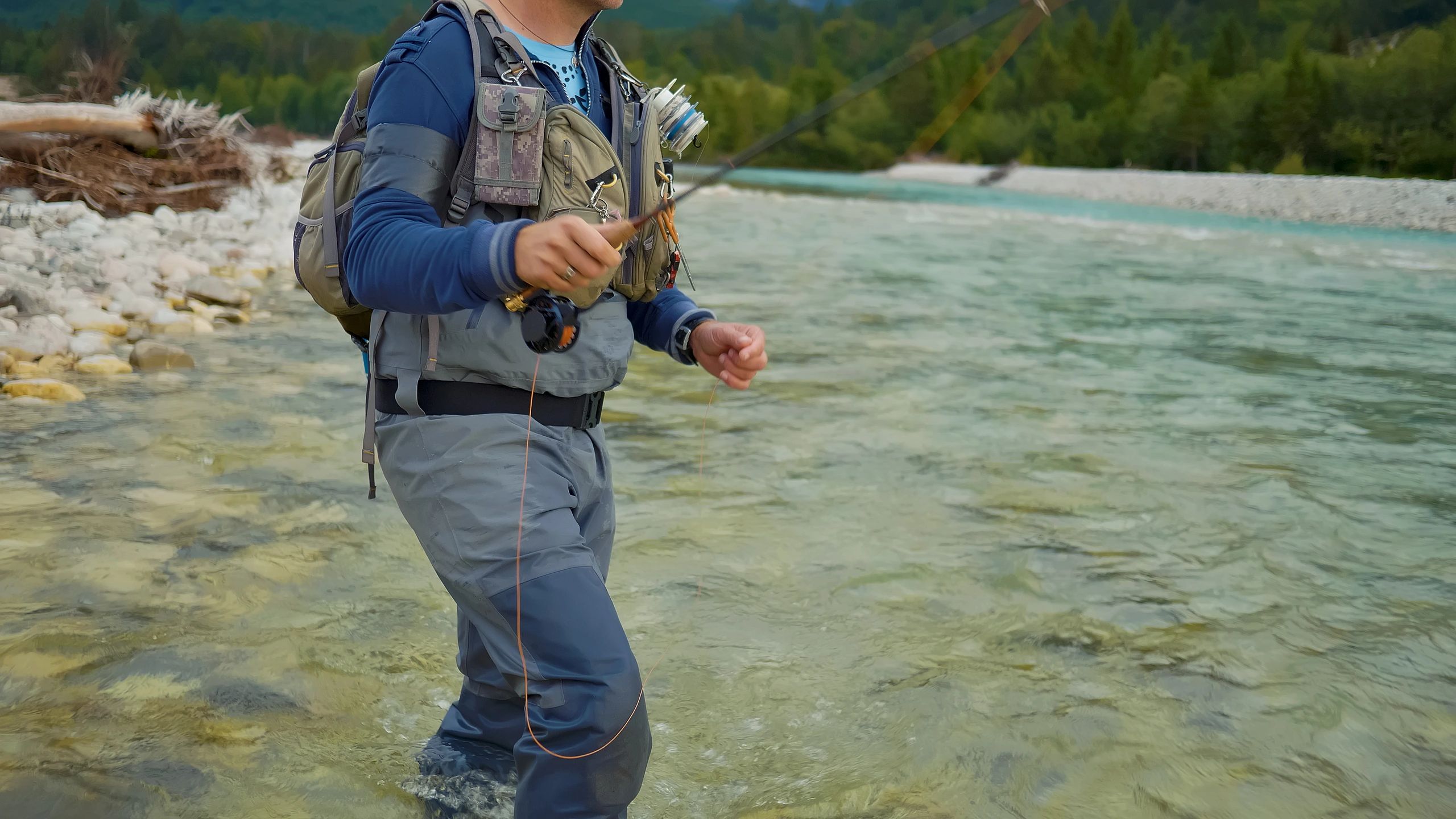 Angler fly-fishing in a scenic freshwater setting